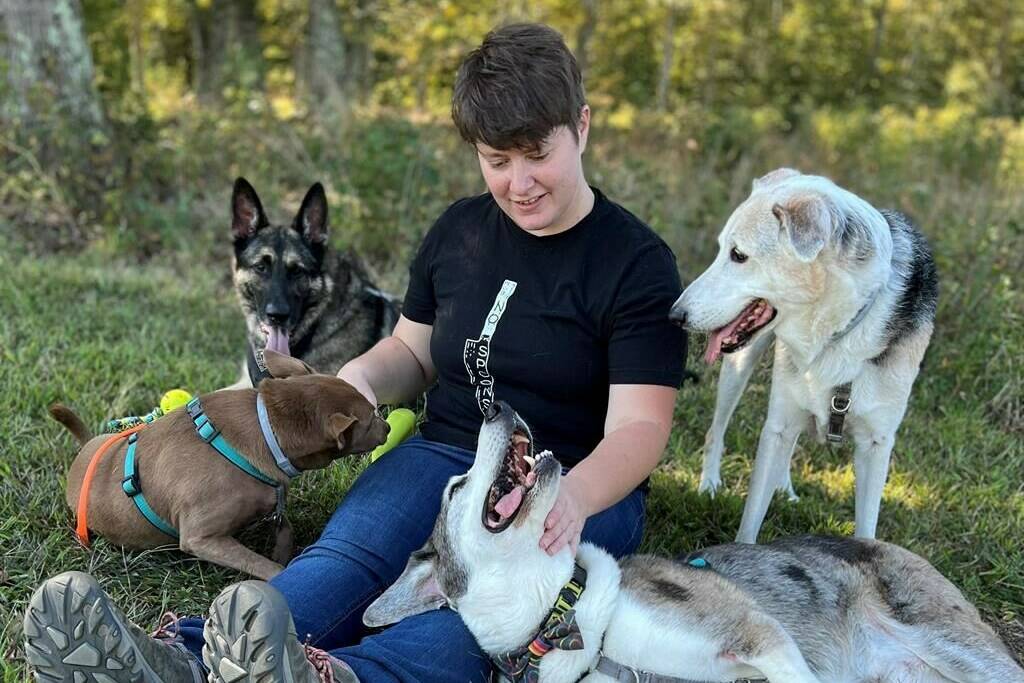 This photo shows certified dog behavior consultant Gabrielle Johnson with her dogs on Oct. 11 in Richmond, Va. Johnson said a little preparation goes a long way for people bringing their pets along on holiday home stays with loved ones. (Josh Mark Rickey via AP)