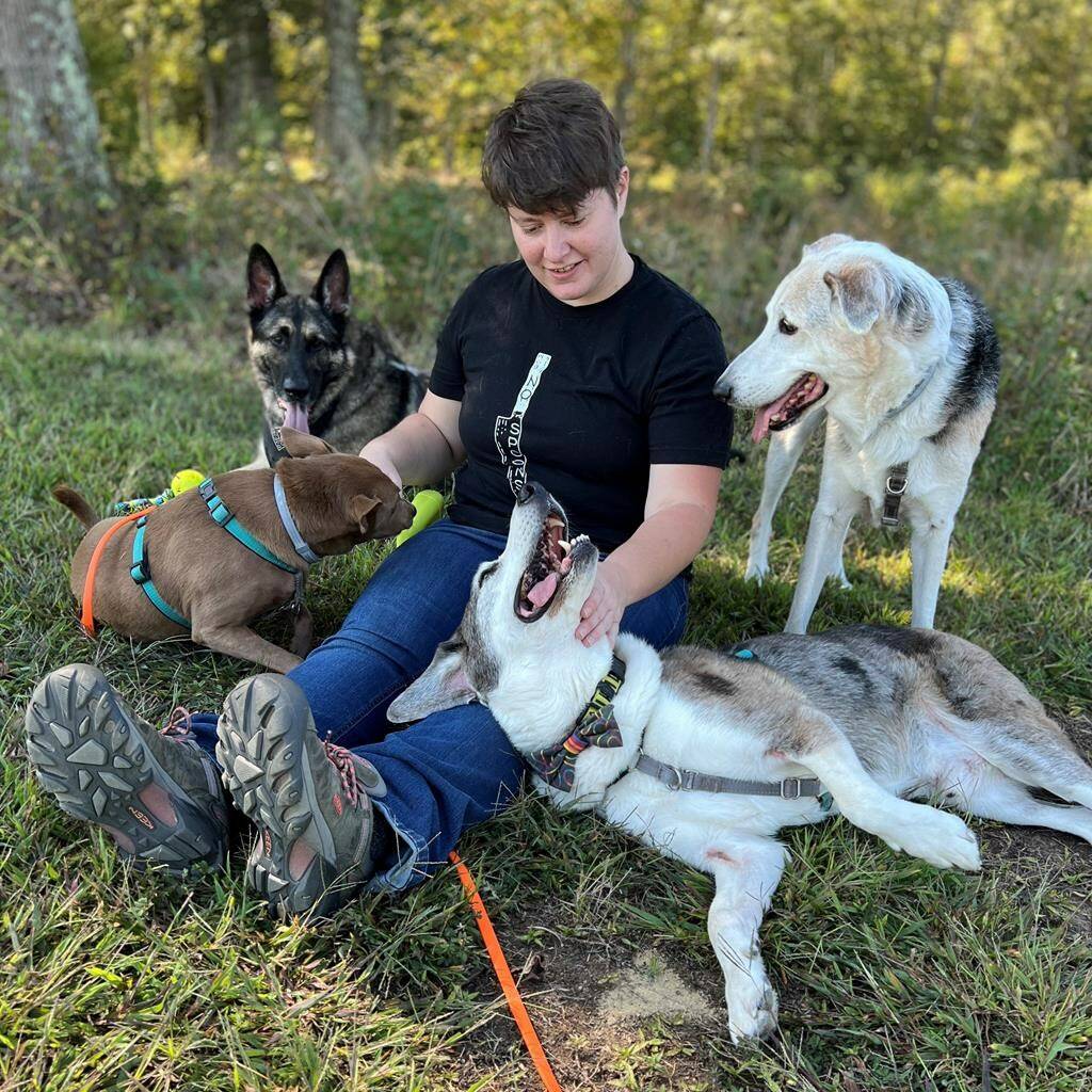 This photo shows certified dog behavior consultant Gabrielle Johnson with her dogs on Oct. 11 in Richmond, Va. Johnson said a little preparation goes a long way for people bringing their pets along on holiday home stays with loved ones. (Josh Mark Rickey via AP)