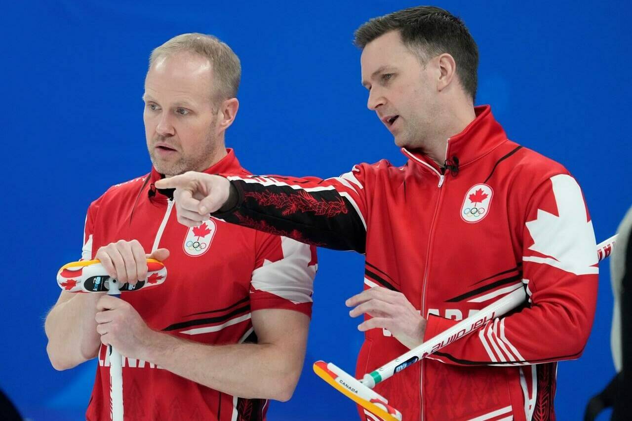 Canada skip Brad Gushue, right, discusses a shot with third Mark Nichols during their bronze medal curling match against the United States Friday, February 18, 2022 at the 2022 Winter Olympics in Beijing. Curling Canada is hoping an ongoing high-performance review will help put the federation on track for success after a disappointing showing on the international stage last season.THE CANADIAN PRESS/Ryan Remiorz