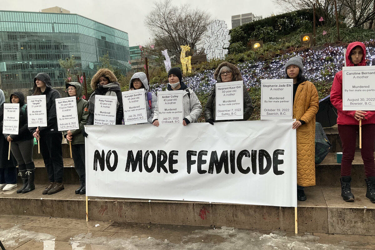 A group of women stood in downtown Vancouver on Dec. 27 holding signs with names of the 10 women who were killed by men in B.C. in 2022. (Vancouver Rape Relief and Women’s Shelter photo)