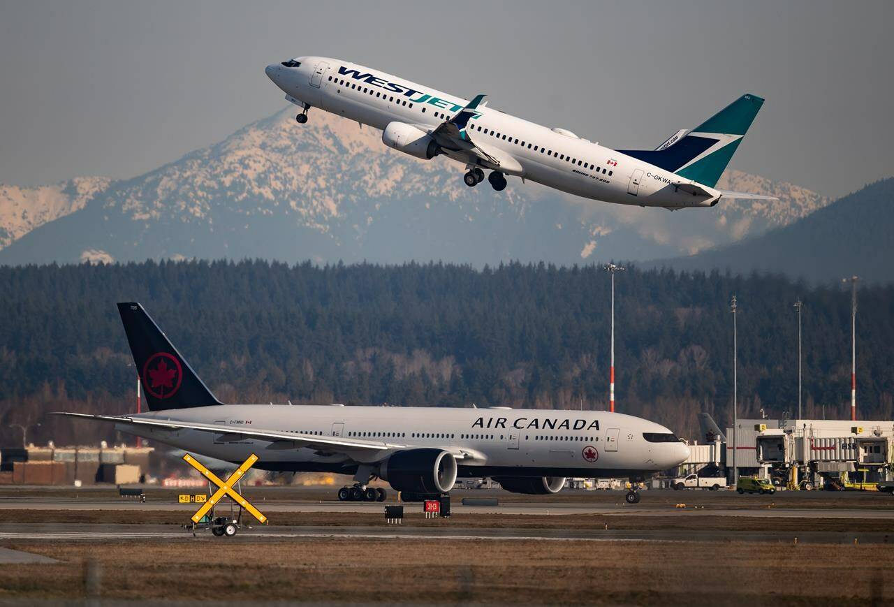 Aviation analytics company Cirium says Canada’s two biggest airlines ranked low in terms of on-time performance this year. The data firm says that among the ten biggest airlines in Canada and the U.S., Air Canada and WestJet Airlines Ltd. ranked worst and second-worst for their punctuality. An Air Canada flight taxis to a runway as a WestJet flight takes off at Vancouver International Airport, in Richmond, B.C., on March 20, 2020. THE CANADIAN PRESS/Darryl Dyck