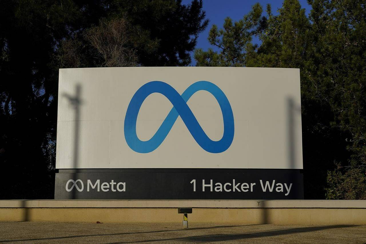 FILE - Meta’s logo can be seen on a sign at the company’s headquarters in Menlo Park, Calif., on Nov. 9, 2022. Irish regulators on Wednesday Jan. 4, 2023 hit Facebook parent Meta with hundreds of millions in fines and banned the company from forcing European users to agree to seeing personalized ads based on their online activity. (AP Photo/Godofredo A. Vásquez, File)