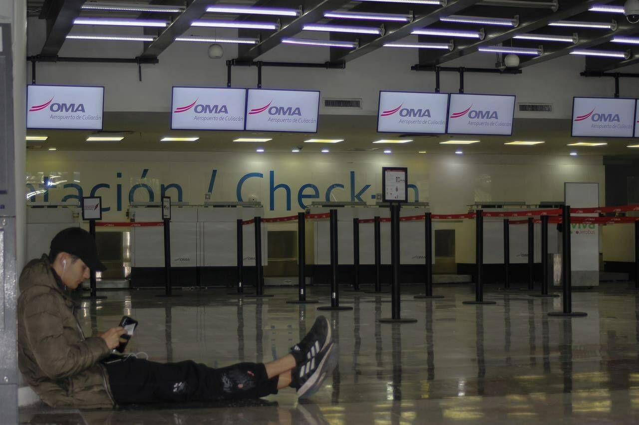 A passenger waits in an empty terminal at the airport while flights are suspended due to drug cartel-related violence in Culiacan, Sinaloa state, Mexico on January 6, 2023. THE CANADIAN PRESS/AP, Martin Urista