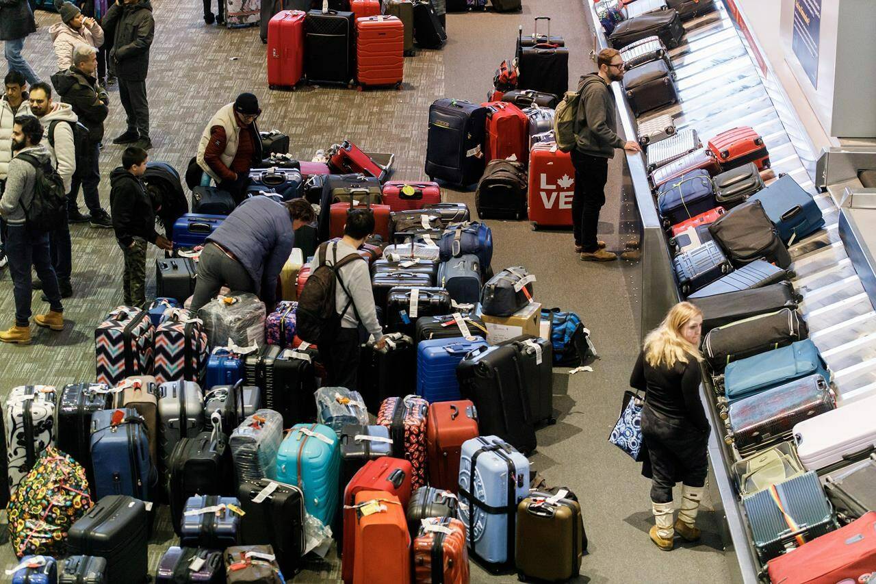 Luggage bags are amassed in the bag claim area at Toronto Pearson International Airport, as a major winter storm disrupts flights in and out of the airport, in Toronto, Saturday, Dec. 24, 2022. From long hours waiting on hold to sleepless nights on airport floors and desperate scrambles to rebook flights and find missing bags, it was a holiday travel season that no one had on their wish list — but that thousands of people got. THE CANADIAN PRESS/Cole Burston