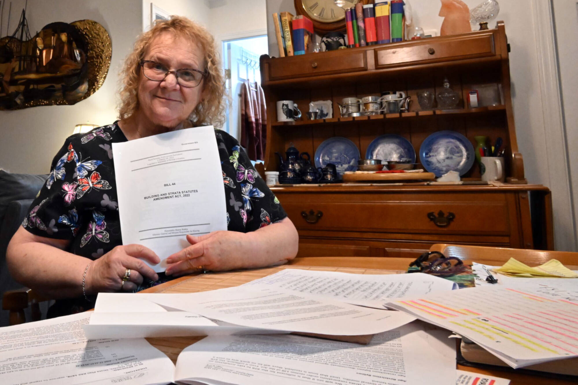 Toni Russell holds up a copy of Bill 44, which removed the ability for stratas to ban rentals or use 19+ age restrictions. Now the strata at Cherry Lane Towers where she lives is trying to turn the condo complex into a 55+ community. (Brennan Phillips - Western News)