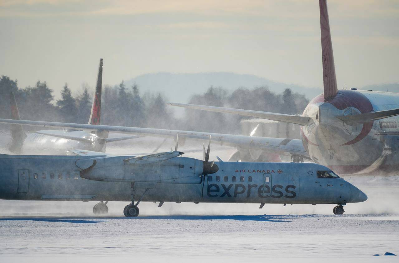 An Air Canada aircraft taxis at Vancouver International Airport in Richmond, B.C., on Wednesday, Dec. 21, 2022. (Darryl Dyck/The Canadian Press)