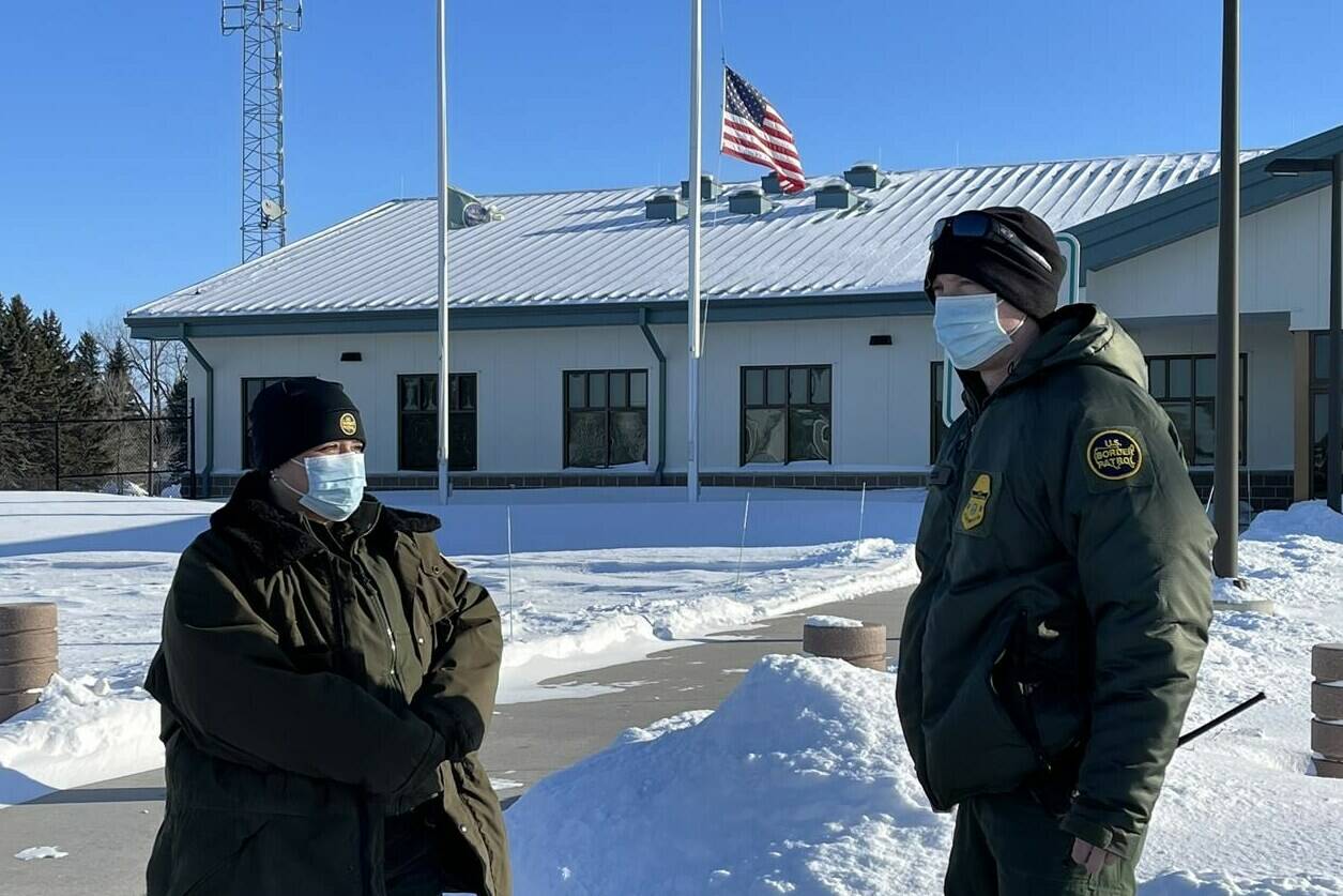 U.S. Border Patrol agents Katy Siemer, left and David Marcus stand outside the Customs and Border Protection facility in Pembina, N.D., on Tuesday, Jan. 25, 2022. A year after a family of four from India froze to death while trying to walk to the United States from Manitoba, the agency tasked with patrolling the border says others have not been deterred from attempting the same treacherous journey. THE CANADIAN PRESS/James McCarten
