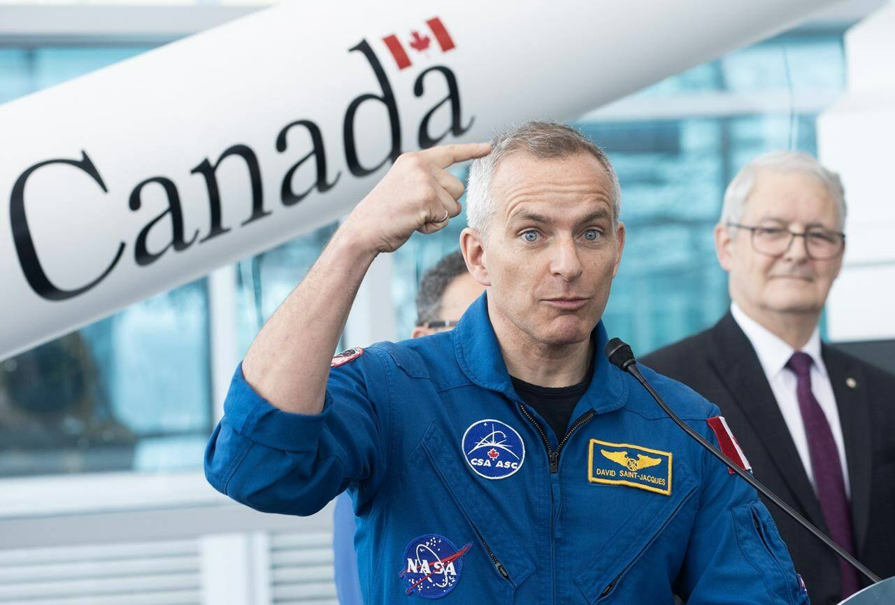 Former astronaut and MP Marc Garneau, right, looks on as Astronaut David Saint-Jacques speaks during a government of Canada announcement supporting commercial space launches, at the Canadian Space Agency in Longueuil, Que., Friday, January 20, 2023. THE CANADIAN PRESS/Graham Hughes