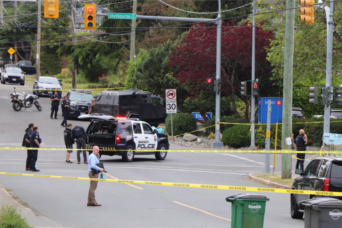 Police personnel surround the area around the BMO branch at Shelbourne and Pear Street in Saanich. A midday bank robbery there was followed by shooting that left two suspects dead and saw six police officers taken to hospital with gunshot wounds. (Black Press Media file photo)
