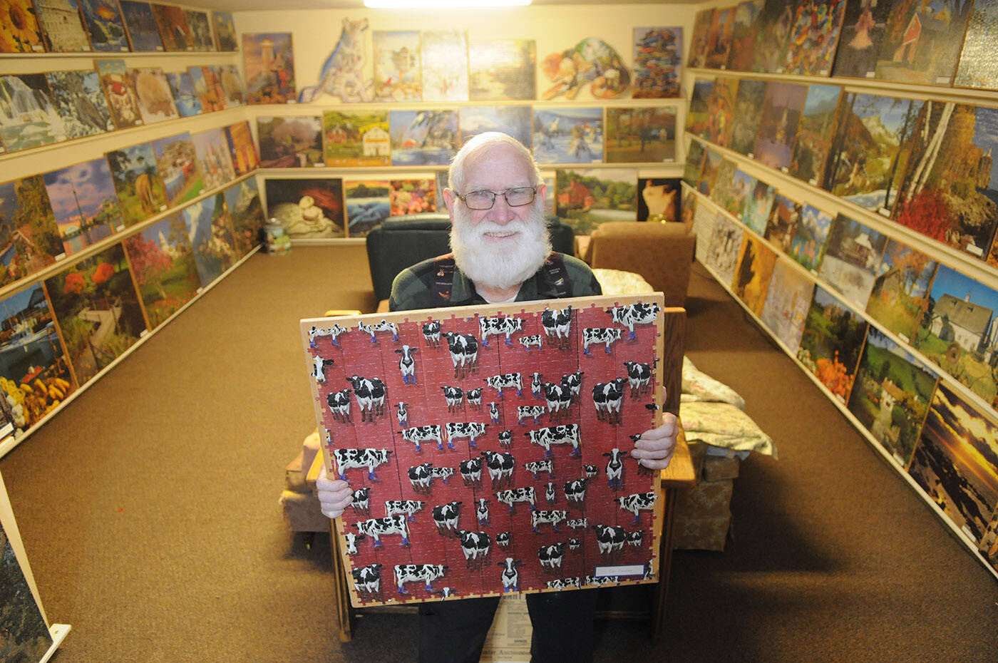Joe Sommer has completed 190 jigsaw puzzles, all of which are on display in the basement of his Chilliwack home. Seen here are about half of the puzzles. (Jenna Hauck/ Chilliwack Progress)