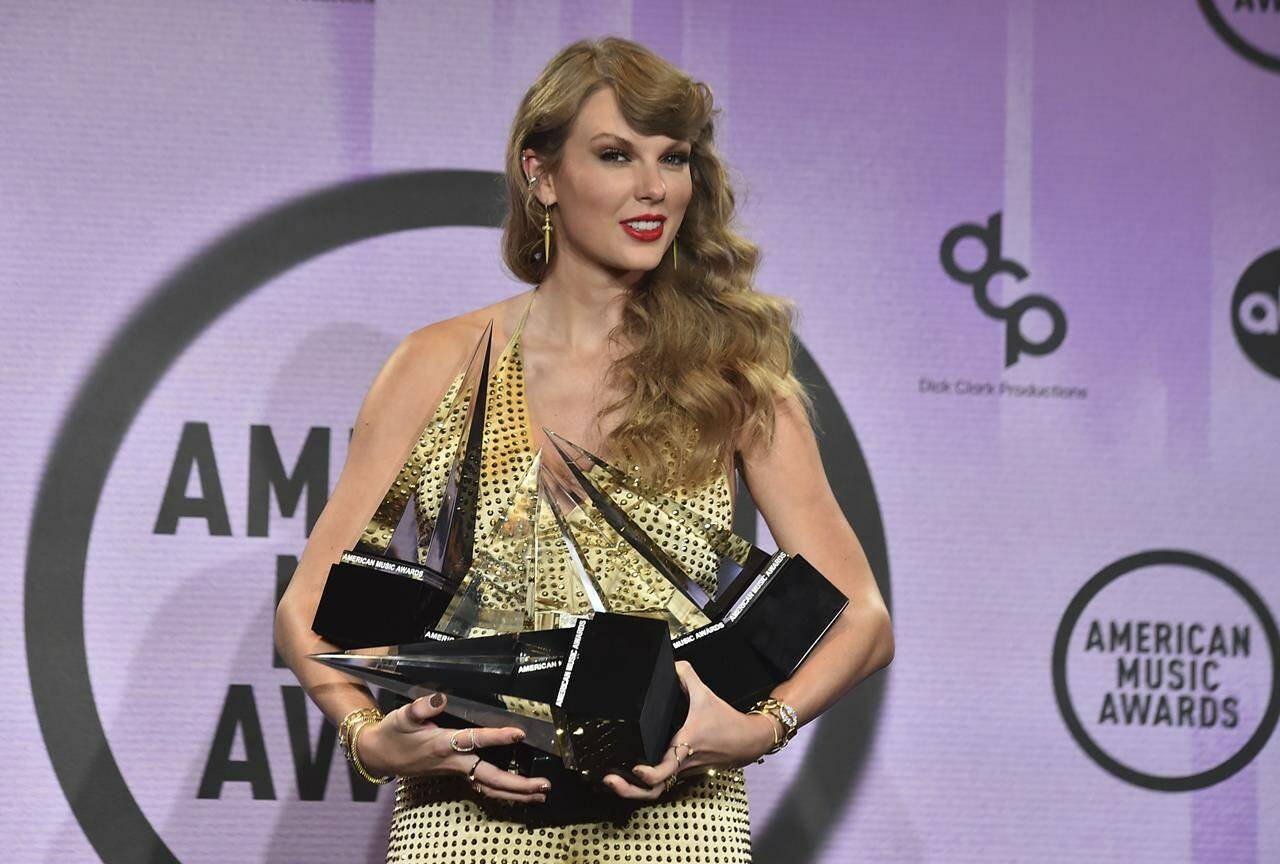FILE - Taylor Swift poses in the press room with awards at the American Music Awards on Sunday, Nov. 20, 2022, at the Microsoft Theater in Los Angeles. Senators are expected to grill Ticketmaster Tuesday, Jan. 24, 2023, about its spectacular breakdown last year during a sale of Taylor Swift concert tickets. (Photo by Jordan Strauss/Invision/AP, File)