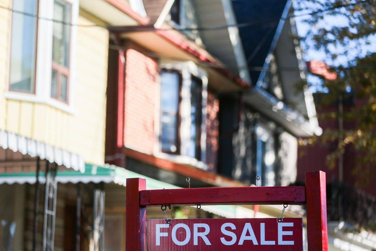 A real estate sign is displayed in front of a house in the Riverdale area of Toronto on Wednesday, September 29, 2021.THE CANADIAN PRESS/Evan Buhler