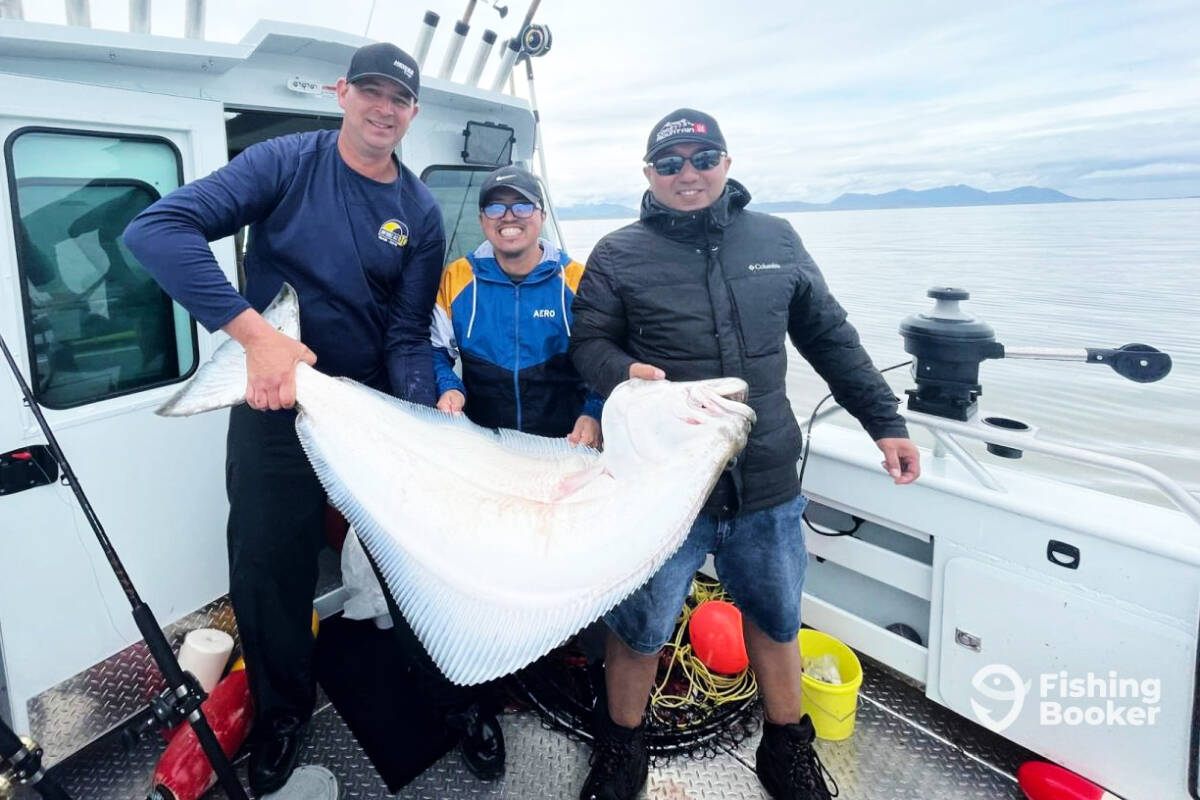 Three fishermen show off a halibut while on a guided fishing trip with CMF Charters, based out of Prince Rupert. (Photo: Supplied)