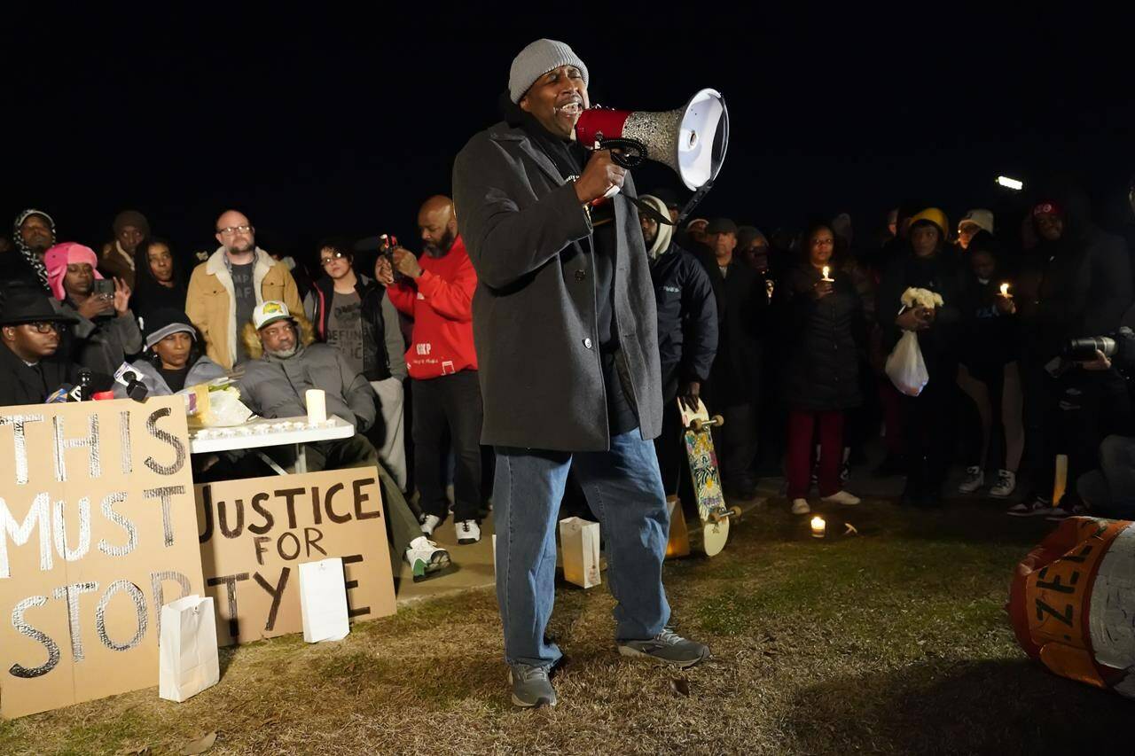 Rev. Andre E Johnson, of the Gifts of Life Ministries, preaches at a candlelight vigil for Tyre Nichols, who died after being beaten by Memphis police officers, in Memphis, Tenn., Thursday, Jan. 26, 2023. Behind at left are Tyre’s mother RowVaughn Wells and his stepfather Rodney Wells. (AP Photo/Gerald Herbert)