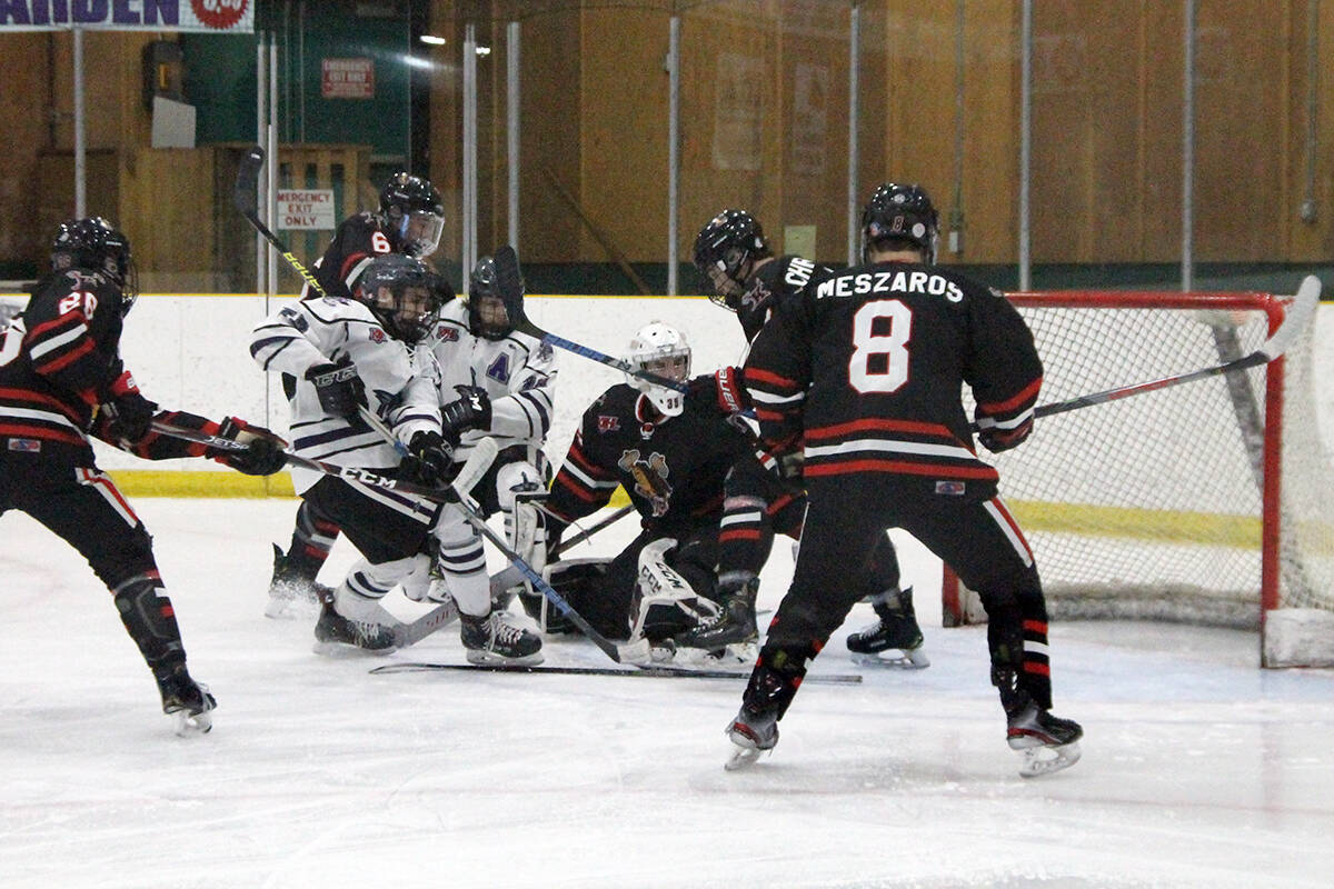 North Okanagan Knights forwards Kevin-Thomas Walters (left, white jersey) and Bryan Brew try to beat four Kelowna defenders and Chiefs goalie Braeden Mitchell during Game 3, KIJHL Divisional semifinal action Monday, March 2, at Armstrong's Nor-Val Sports Centre. (Roger Knox - Black Press)