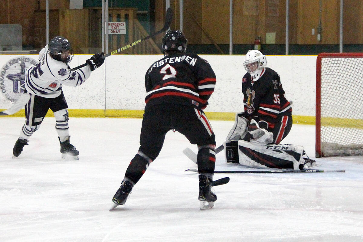 Kelowna Chiefs goalie Braeden Mitchell stones North Okanagan Knights shooter Bryan Brew from in-close while Kelowna defenceman Nathan Christensen looks to clear any rebound during Game 3 action of the teams' KIJHL Divisional semifinal action Monday, March 2, at Armstrong's Nor-Val Sports Centre. (Roger Knox - Black Press)