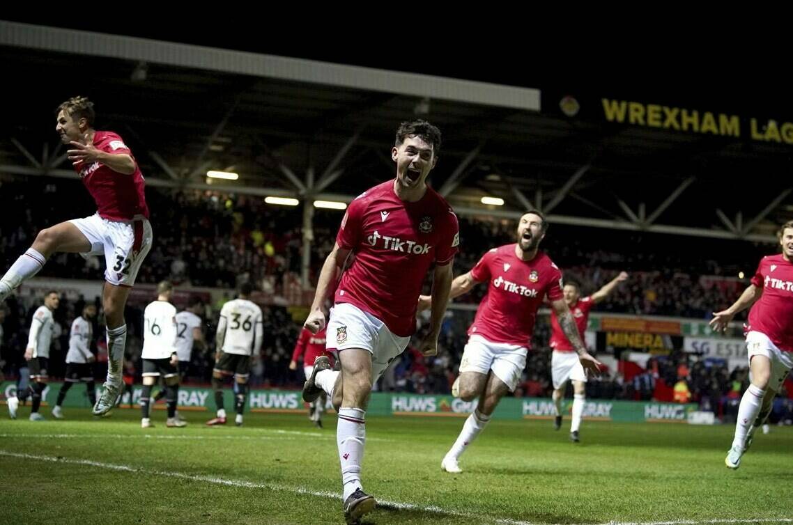 Wrexham’s Tom O’Connor celebrates scoring against Sheffield United during the English FA Cup fourth round soccer match at The Racecourse Ground, Wrexham, Wales, Sunday Jan. 29, 2023. (Peter Byrne/PA via AP)