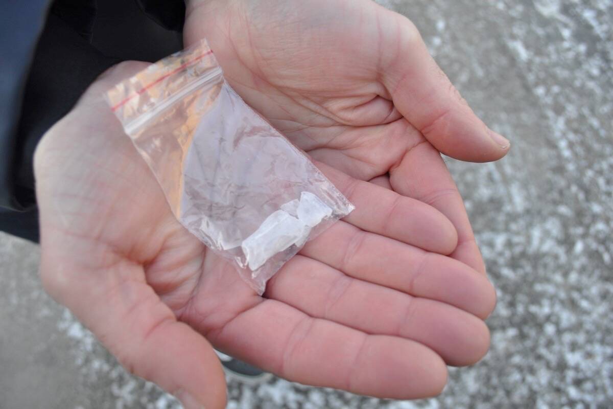 A person in Nelson holds a bag with 2.5 grams of methamphetamine. Possession of that amount of certain types of drugs, including meth, will be decriminalized in B.C. as of Jan. 31. Photo: Tyler Harper