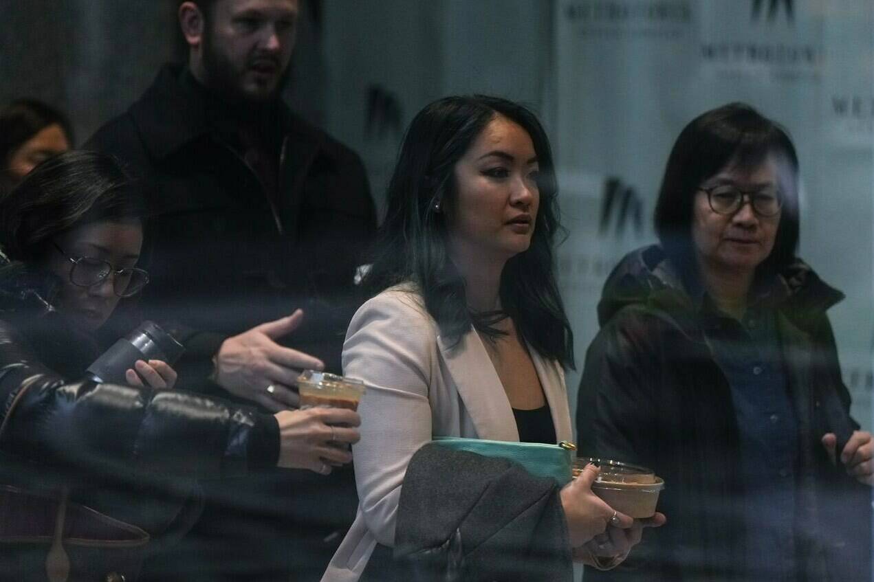 Jennifer Chan, front centre, the sister of late Vancouver Police Const. Nicole Chan, who died by suicide in 2019, returns to a coroner’s inquest, in Burnaby, B.C., on Monday, Jan. 23, 2023. A Vancouver Police sergeant who says he was Nicole Chan’s friend and mentor has told a coroner’s inquest that Chan believed she would never return to work because human resource officers went to the hospital when she was apprehended under the Mental Health Act. THE CANADIAN PRESS/Darryl Dyck