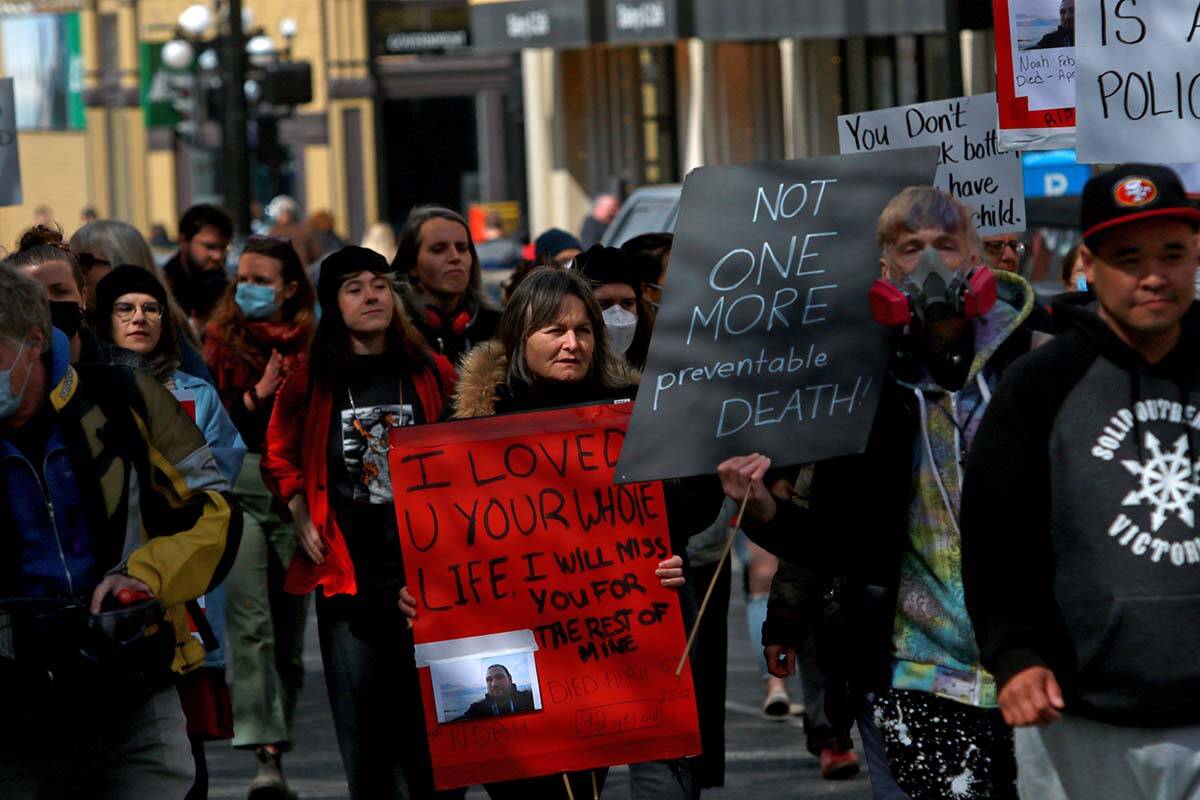 Moms Stop the Harm advocates and supporters march from Centennial Square to the Ministry of Health building in Victoria on April 14, 2022, the sixth anniversary of B.C. declaring the opioid crisis a public health emergency. THE CANADIAN PRESS/Chad Hipolito