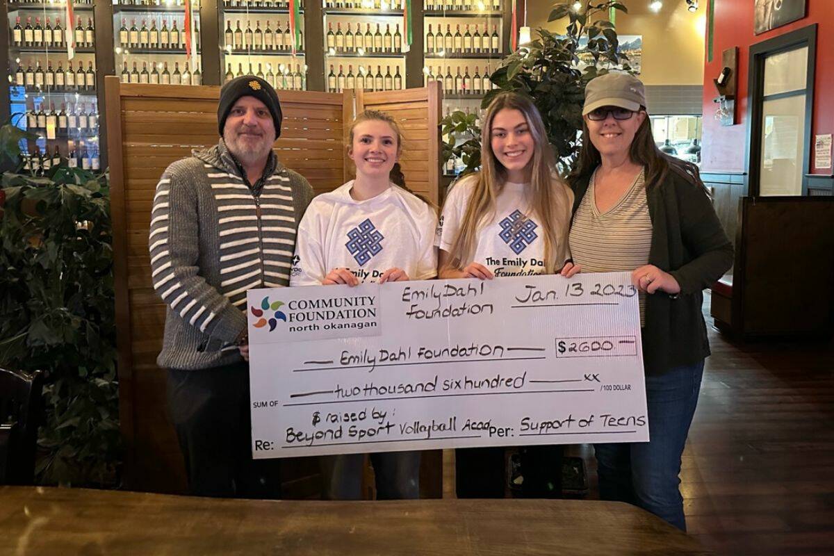 Abby Lawlor and Mollie English (white shirts) present a $2,600 check to Sherman Dahl (The Emily Dahl Foundation) and Leanne Hammond (Community Foundation) on behalf of Beyond Sport Volleyball Academy. (Contributed)