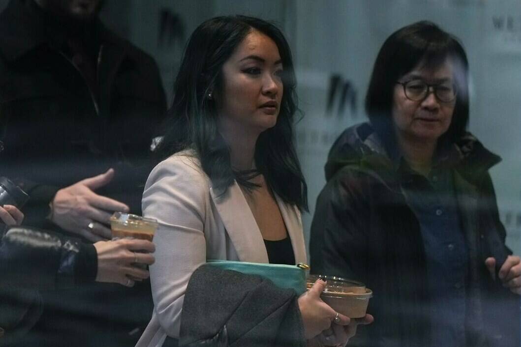 Jennifer Chan, front centre, the sister of late Vancouver Police Const. Nicole Chan, who died by suicide in 2019, returns to a coroner’s inquest, in Burnaby, B.C., on Monday, Jan. 23, 2023.THE CANADIAN PRESS/Darryl Dyck