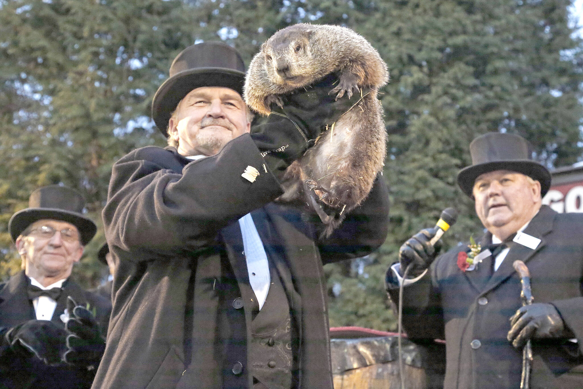 Groundhog Club handler John Griffiths, center, holds Punxsutawney Phil, the weather prognosticating groundhog, during the 131st celebration of Groundhog Day on Gobbler’s Knob in Punxsutawney, Pa., Thursday, Feb. 2, 2017. . (AP Photo/Gene J. Puskar)