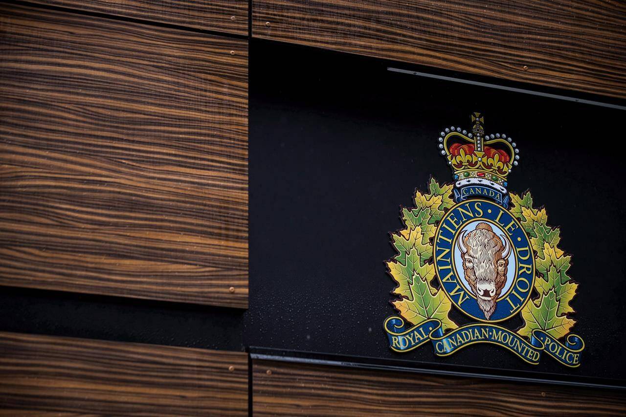 The RCMP logo is seen outside Royal Canadian Mounted Police “E” Division Headquarters, in Surrey, B.C., on Friday April 13, 2018. Two RCMP officers have been accused of manslaughter over the death of an Indigenous man in British Columbia, while three of their fellow Mounties are charged with attempting to obstruct justice.THE CANADIAN PRESS/Darryl Dyck