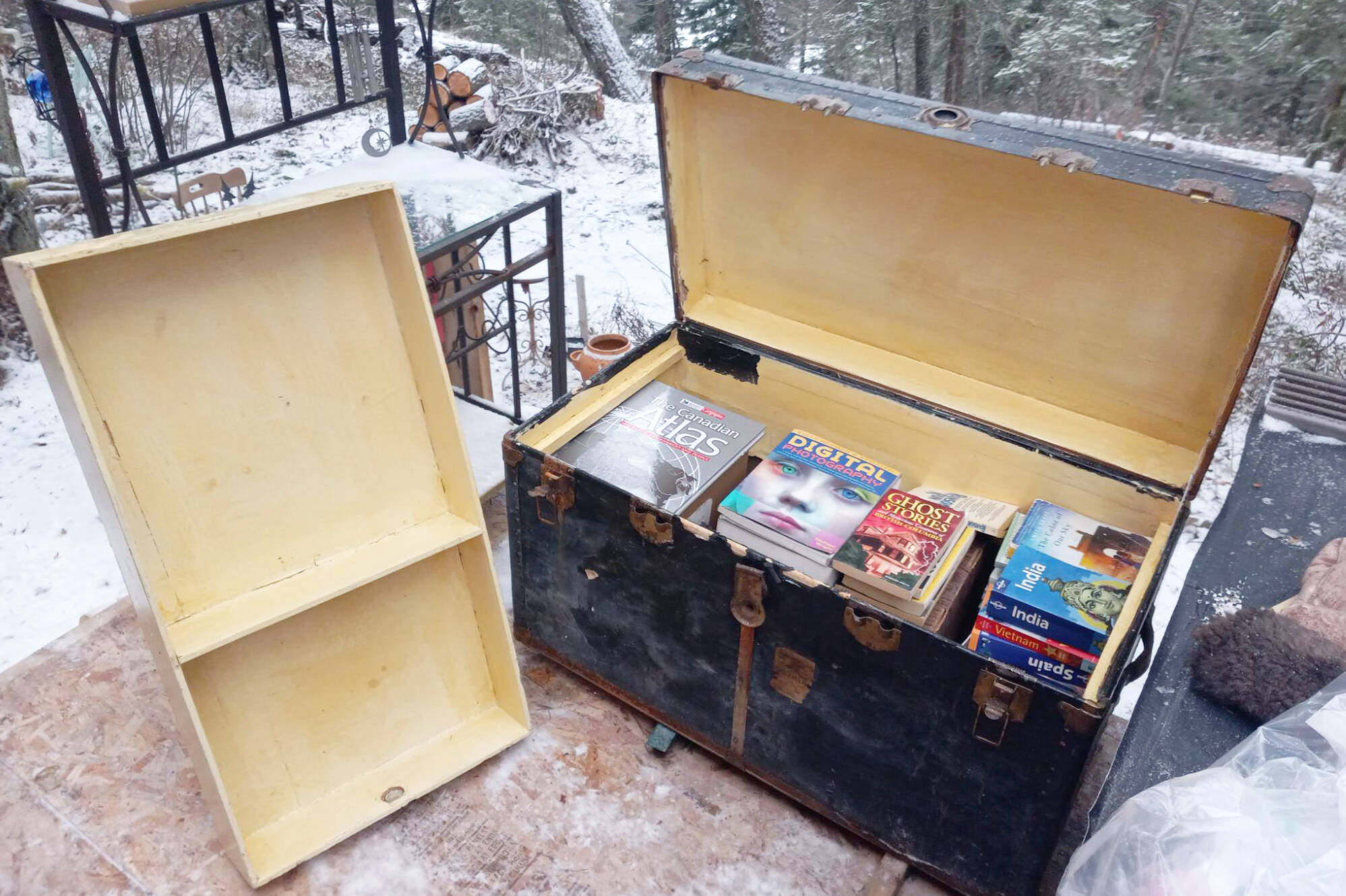Pilinka Wiseman has furnished almost her entire trailer and outdoor area where she lives with things she has taken from the Share Shack at the Scotch Creek Refuse Transfer Station, including a trunk full of books and shelving. (Pilinka Wiseman photo)