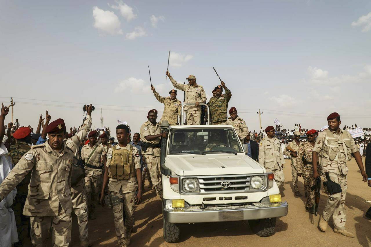 File - Gen. Mohammed Hamdan Dagalo, the deputy head of the military council, waves to a crowd during a military-backed tribe’s rally, in the Nile River State, Sudan, Saturday, , on July 13, 2019. The US is making efforts to convince power brokers in Libya and Sudan to expel the Russian private military company Wagner, regional officials tell The Associated Press. The pressure comes after Washington expanded sanctions on the group. Wagner has played a role in Libya’s conflict but has also been linked with a powerful Sudanese paramilitary. (AP Photo/Mahmoud Hjaj, File)
