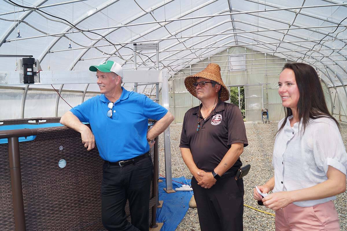Local MLA John Horgan and T’Sou-ke Nation Chief Gordie Planes listen to an explanation from Synergraze founder and CEO Tamara Loiselle on how the spore tank works at a demonstration project in a greenhouse that’s home to an innovative project aimed at reducing methane gas emissions from livestock. (Rick Stiebel-Sooke News Mirror)