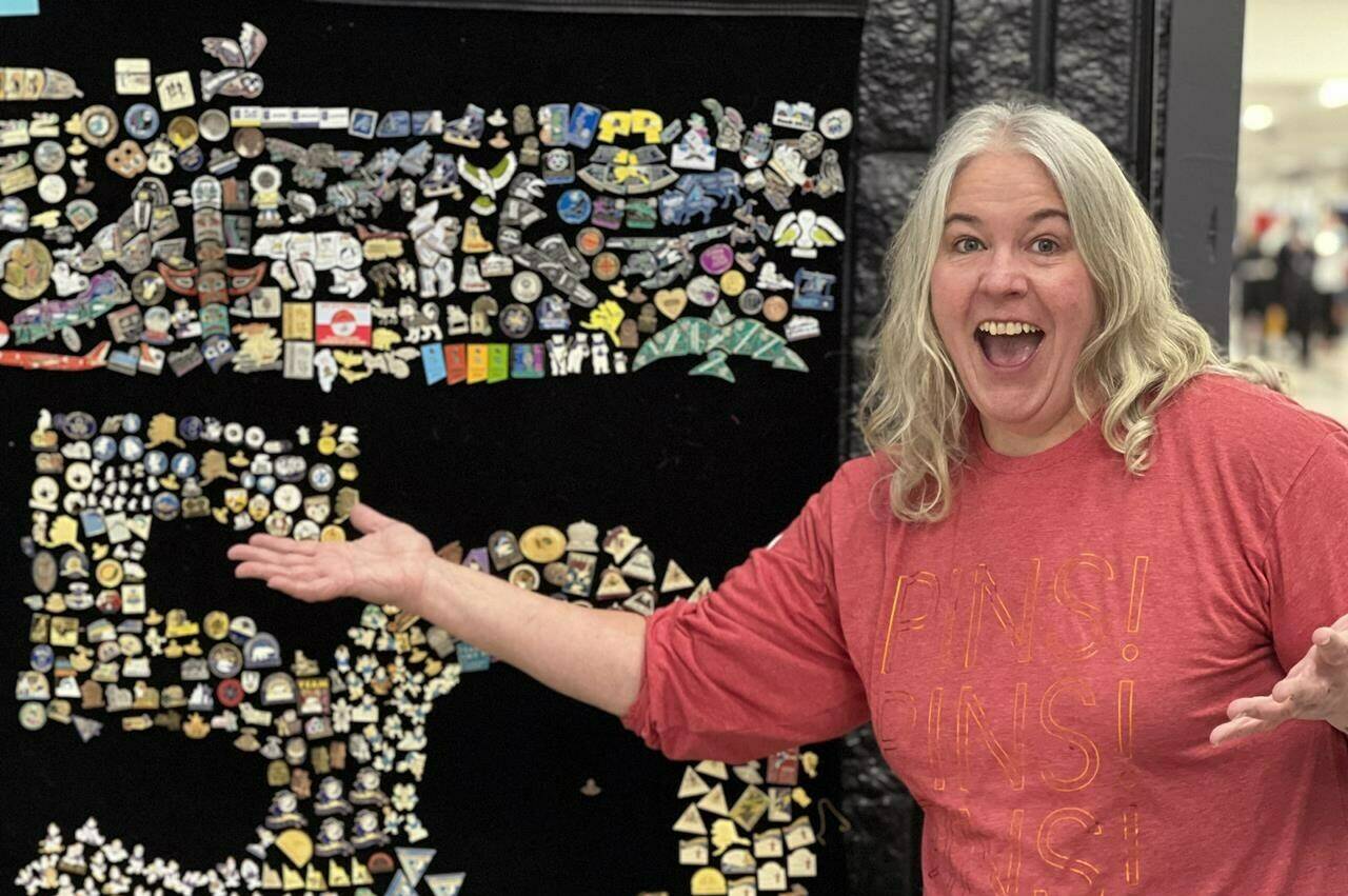 Janet Pacey from Yellowknife poses with some of the Arctic Winter Games pins that she has collected over the years in this Friday, February 3, 2023 handout photo. New and seasoned pin traders, affectionately known as “pinheads” can often be found at the biennial sporting event swapping pins from across the circumpolar north or on the hunt for rare ones to add to their trove. THE CANADIAN PRESS/HO, Janet Pacey *MANDATORY CREDIT*
