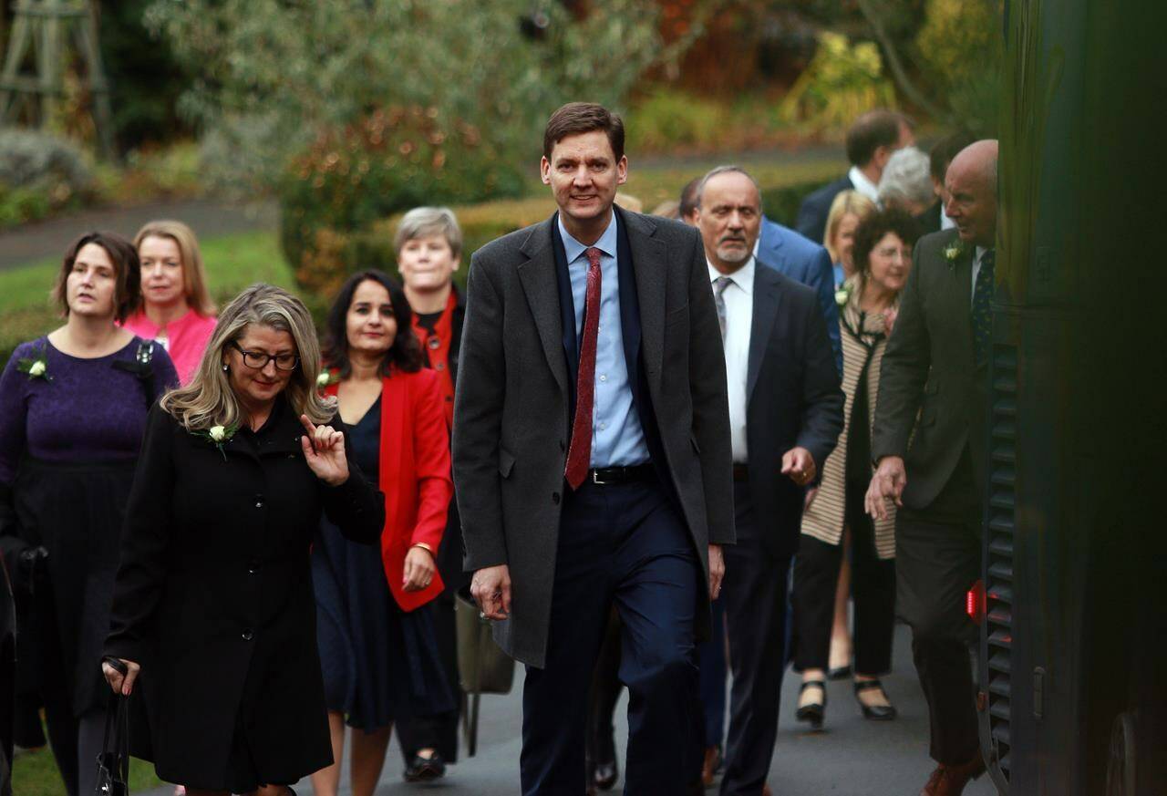 Premier David Eby arrives with ministers before the start of the swearing-in ceremony at Government House in Victoria, B.C., on Wednesday, Dec. 7, 2022. B.C. politicians are returning to the legislature for the spring sitting, starting with a throne speech laying out the government’s goals for the months ahead. THE CANADIAN PRESS/Chad Hipolito