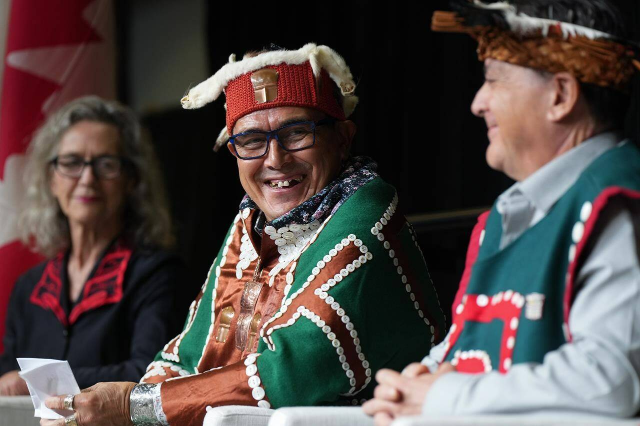 Chief John Powell, centre, of the Mamalilikulla First Nation, sits with Joyce Murray, back left, Minister of Fisheries, Oceans and the Canadian Coast Guard, and former chief Richard Sumner during an announcement about a new marine refuge in the Gwaxdlala/Nalaxdlala (Lull Bay/Hoeya Sound) area in Knight Inlet on B.C.’s central coast, at the International Marine Protected Areas Congress (IMPAC5) in Vancouver, on Sunday, February 5, 2023. The federal and British Columbia governments alongside 15 coastal First Nations have officially endorsed the blueprint for a vast network of marine protected areas along the west coast of Canada. THE CANADIAN PRESS/Darryl Dyck