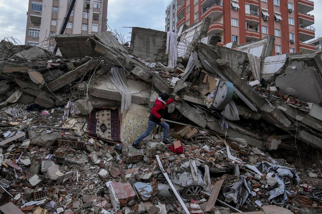 A man walks among rubble as he searches for people in a destroyed building in Adana, Turkey, Monday, Feb. 6, 2023.  <i data-stringify-type="italic" style="box-sizing: inherit; color: rgb(29, 28, 29); font-family: Slack-Lato, Slack-Fractions, appleLogo, sans-serif; font-size: 15px; font-variant-ligatures: common-ligatures; orphans: 2; widows: 2; background-color: rgb(248, 248, 248); text-decoration-thickness: initial;">Prime Minister Justin Trudeau says Canada “stands ready” to provide help after a powerful earthquake toppled buildings and killed thousands of people in Turkey and Syria. THE CANADIAN PRESS/</em>AP/Khalil Hamra