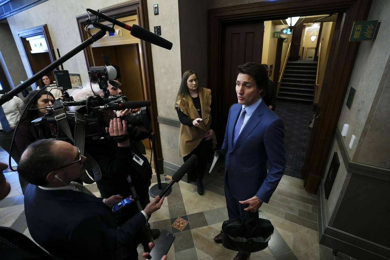 Prime Minister Justin Trudeau talks to reporters in the foyer as he arrives for question period in the House of Commons on Parliament Hill in Ottawa on Monday, Feb. 6, 2023. Trudeau is joining Canada’s premiers at the table today where he is set to offer them a significant increase towards health-care funding. THE CANADIAN PRESS/Sean Kilpatrick