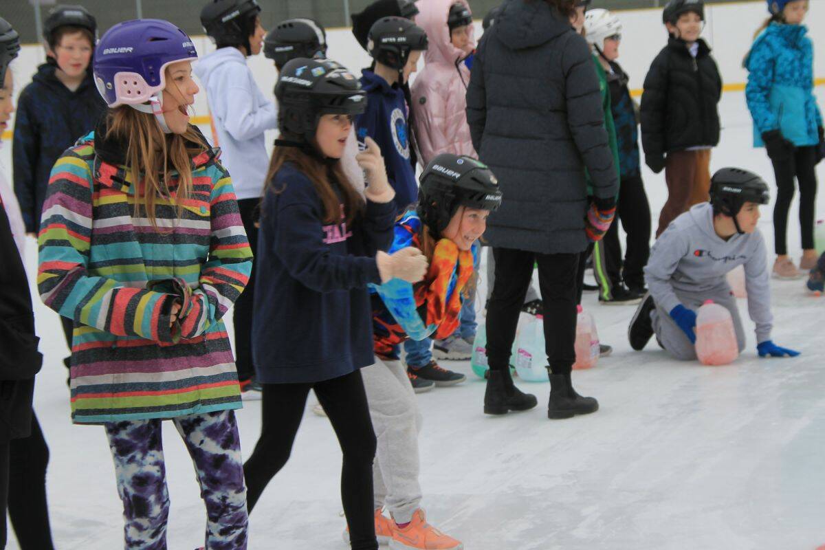 Grade 4 and 5 students at Alexis Park Elementary try their hand at curling on Tuesday, Feb. 7 (Bowen Assman/Vernon Morning Star)