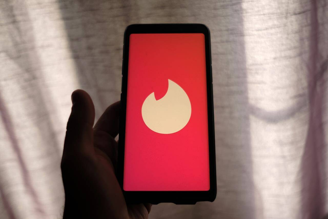 The Tinder dating app logo is seen on a smartphone in Toronto, Thursday, July 9, 2020. For a monthly or annual fee, there are many dating apps and sites that will give you access to their pool of suitors. Others like Hinge, Tinder, Grindr and Bumble have free versions along with paid tiers or features that banish ads, let users’ message prospective dates before matching or boost one’s profile. THE CANADIAN PRESS/Giordano Ciampini