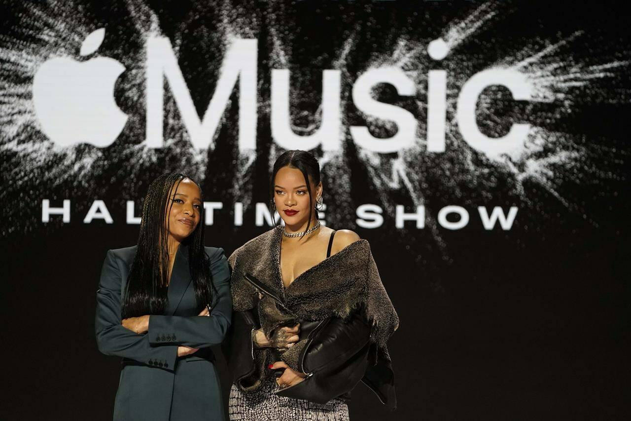 Apple Music’s Nadeska Alexis, left, poses for a photo with Rihanna after a halftime show news conference ahead of the Super Bowl 57 NFL football game, Thursday, Feb. 9, 2023, in Phoenix. (AP Photo/Mike Stewart)