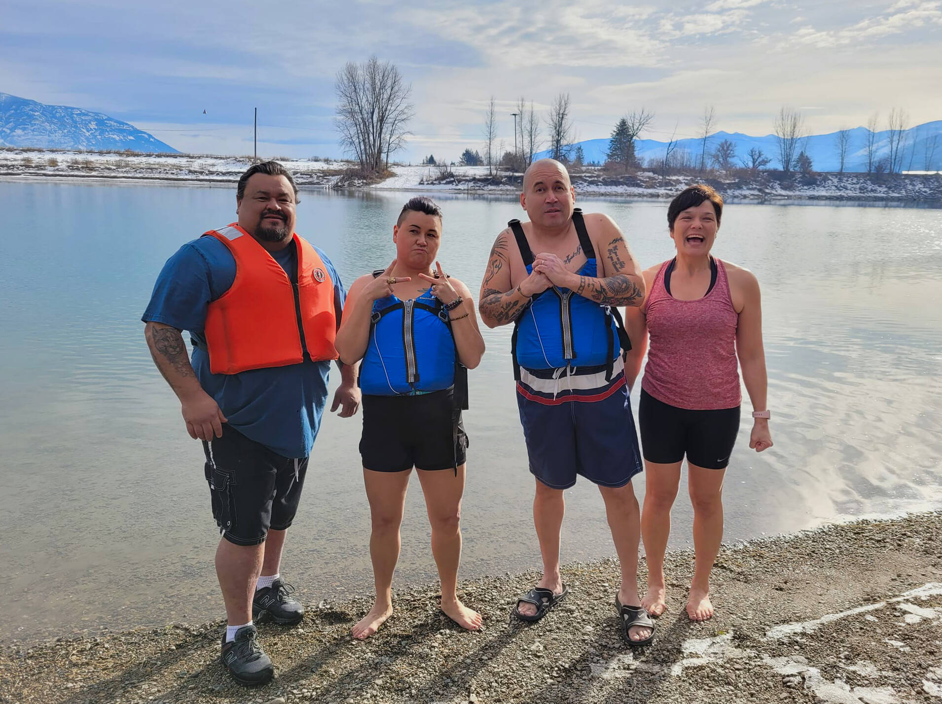 From left to right: Lower Kootenay Band council members Chad Luke, Cherie Luke, Nasukin Jason Louie, and Creston town councillor Denise Dumas get ready for an icy plunge into the Kootenay River on Feb. 3. (Photo by Kelsey Yates)