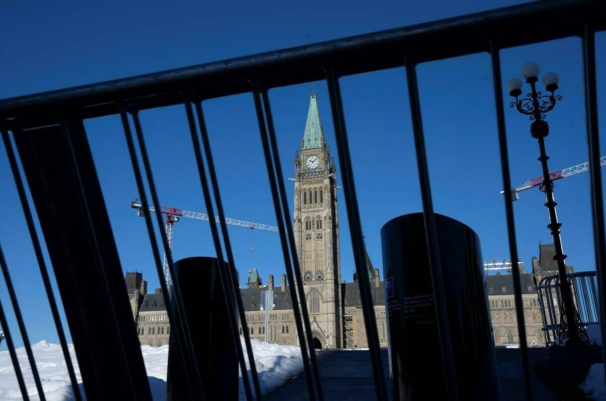 Protesters returned to Ottawa in significantly smaller numbers today to mark the one-year anniversary of the Liberal government’s invocation of the Emergencies Act. Increased temporary security measures are seen blocking access to Parliament Hill, Tuesday, Feb. 14, 2023 in Ottawa.THE CANADIAN PRESS/Adrian Wyld
