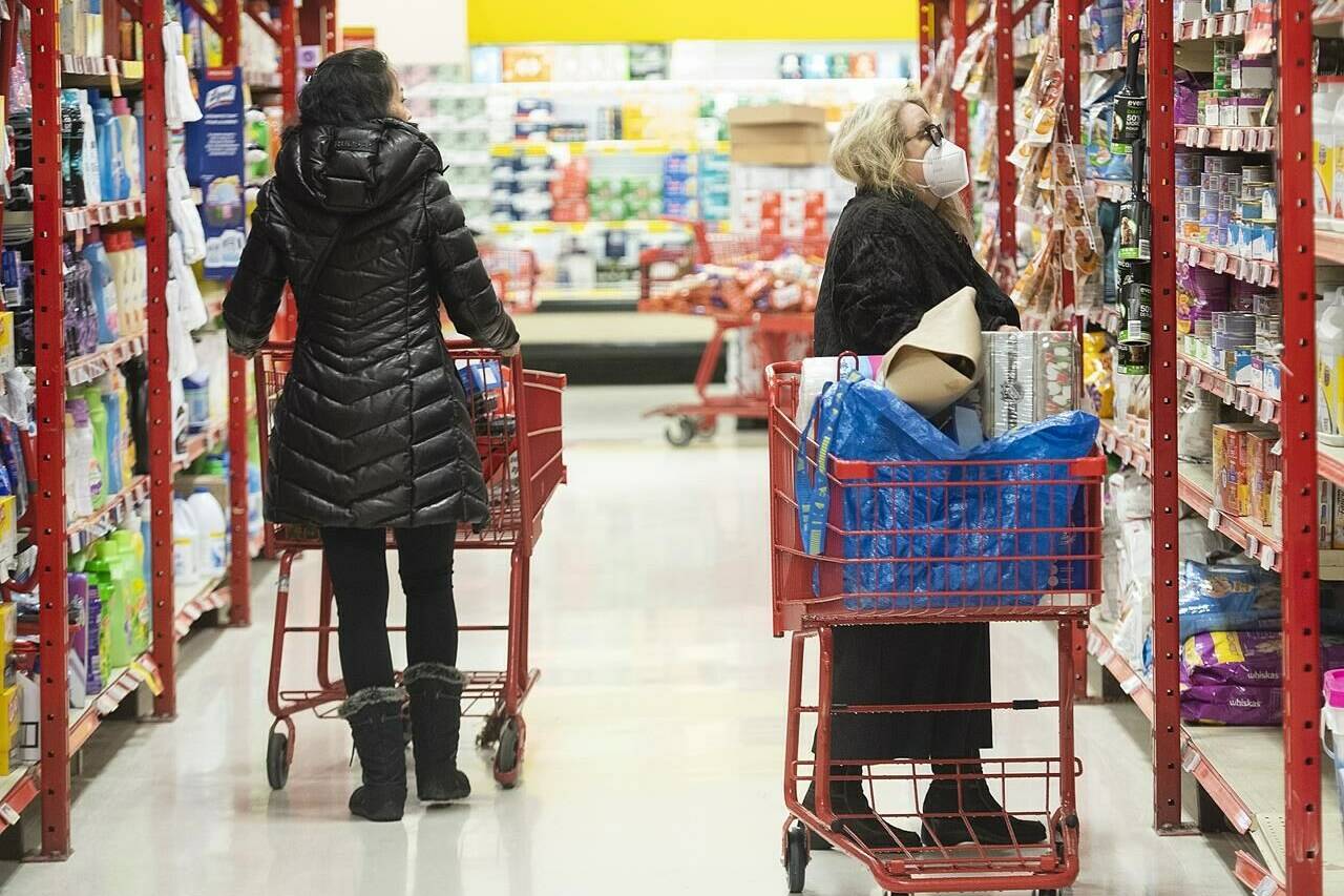 People shop in a grocery store in Montreal, Wednesday, November 16, 2022. The CEOs of Canada’s largest grocery store chains have been summoned to a House of Commons committee to answer for rising grocery prices. THE CANADIAN PRESS/Graham Hughes
