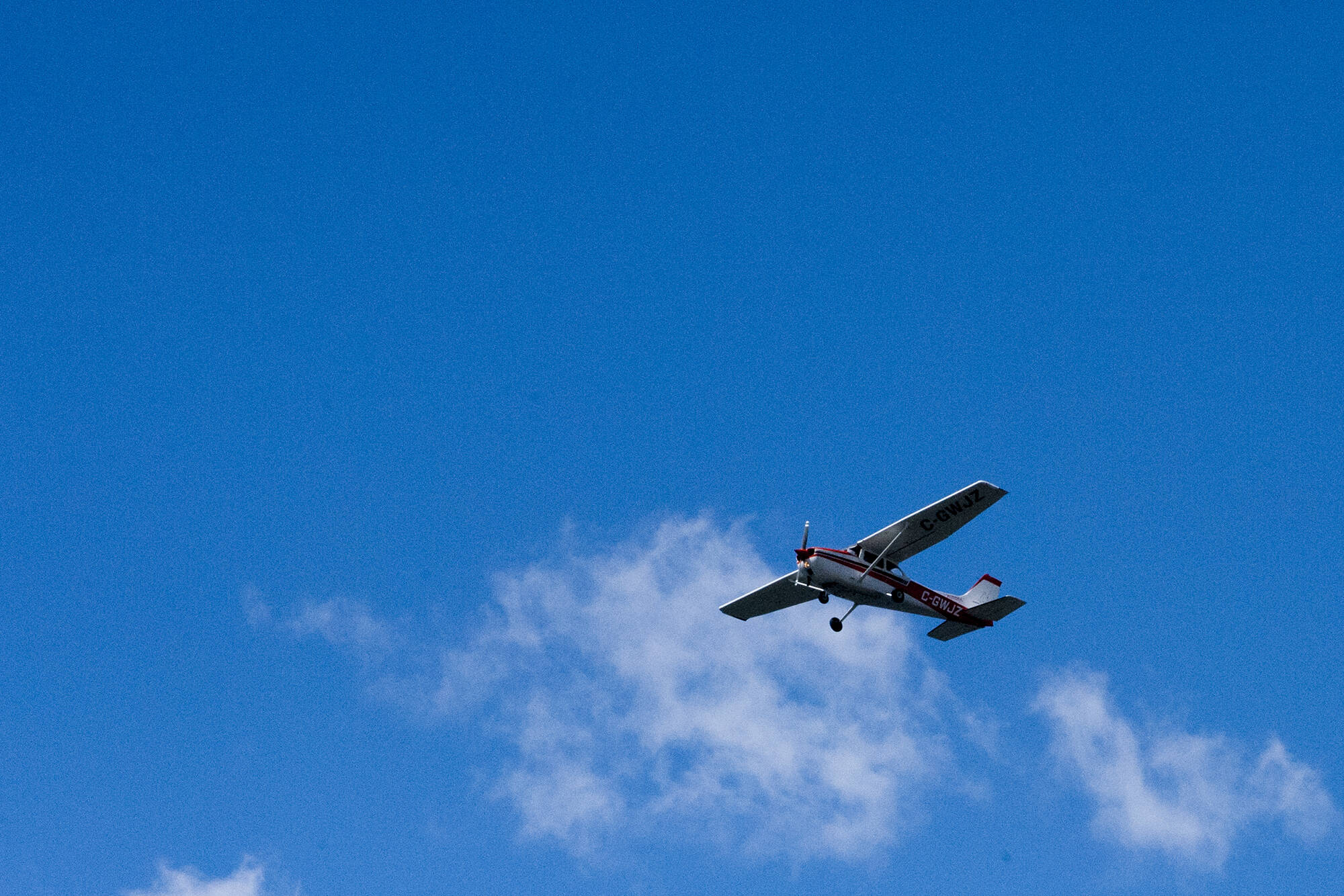A plane flying over Okanagan Lake near downtown Kelowna on May 18, 2020. (Michael Rodriguez - Capital News)