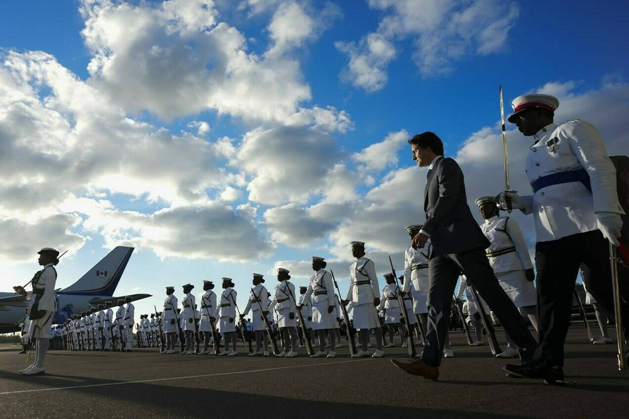 Prime Minister Justin Trudeau inspects an honour guard as he arrives in Nassau, Bahamas, on Wednesday, Feb. 15, 2023. THE CANADIAN PRESS/Sean Kilpatrick