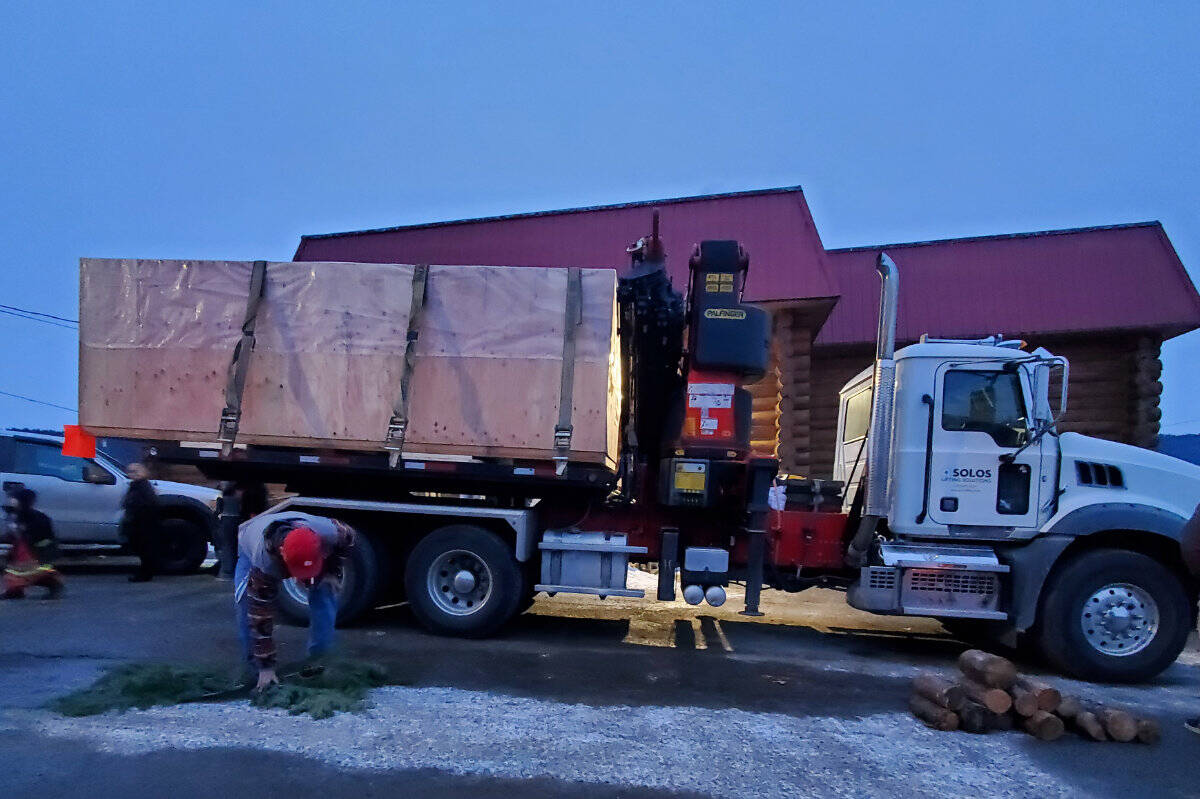 The truck and flatbed carrying the repatriated Nuxalk totem pole was stationed outside the Elizabeth Grouse Gym at Sugar Cane Wednesday, Feb. 15 while Williams Lake First Nation hosted the Nuxalk convoy for a ceremony. (Monica Lamb-Yorski photo - Williams Lake Tribune)