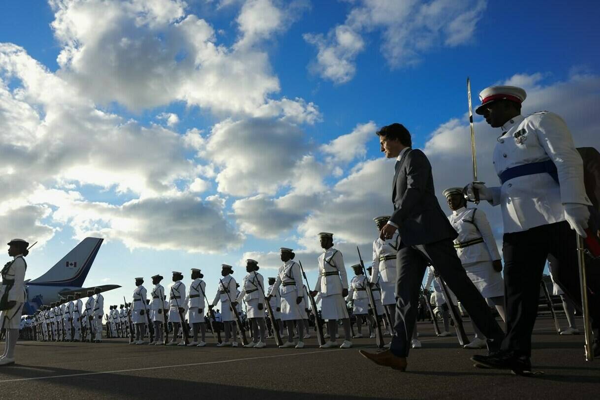 Prime Minister Justin Trudeau inspects an honour guard as he arrives in Nassau, Bahamas, on Wednesday, Feb. 15, 2023. THE CANADIAN PRESS/Sean Kilpatrick