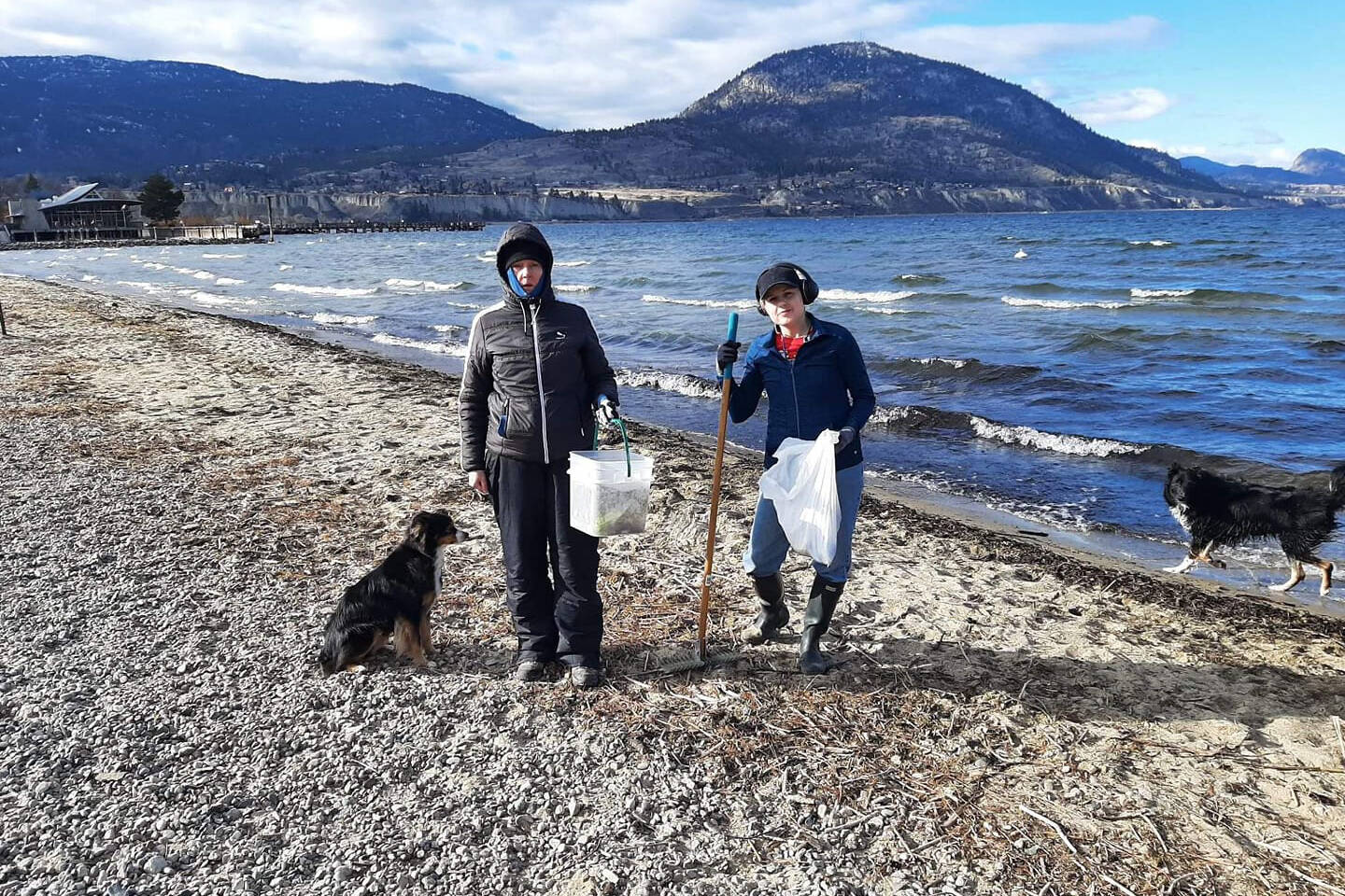 Pet Friendly Penticton founder Kona Sankey and another volunteer spent a windy Monday cleaning up the dog beach at Okanagan Lake during Acts of Kindness week in Penticton. (Submitted)