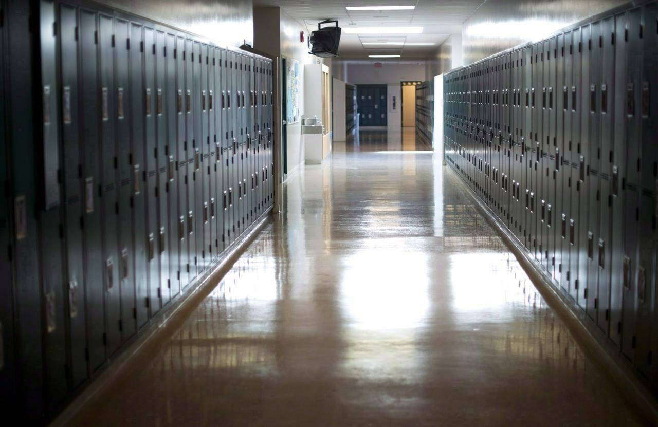 A empty hallway is seen at a school in Vancouver, on Sept. 5, 2014. A retired North Vancouver elementary school teacher is facing a dozen charges connected to alleged assaults that date back more than 40 years. THE CANADIAN PRESS/Jonathan Hayward