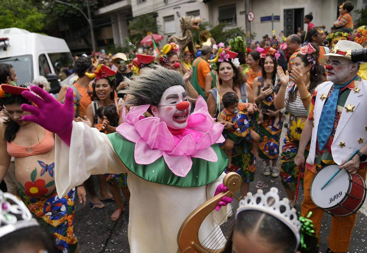 Revelers participate in the “Gigantes da Lira” street block party in Rio de Janeiro, Brazil, Sunday, Feb. 12, 2023. Merrymakers are taking to the streets for the open-air block parties, leading up to Carnival’s official Feb. 17th opening. (AP Photo/Silvia Izquierdo)