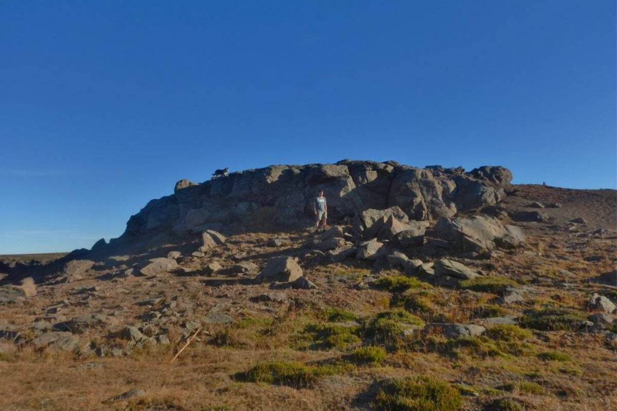 John Pettinger stands below the “Huge Rock” described by Alexander Mackenzie in 1793 as he approached the Pacific Ocean. (Harvey Thommasen photo)